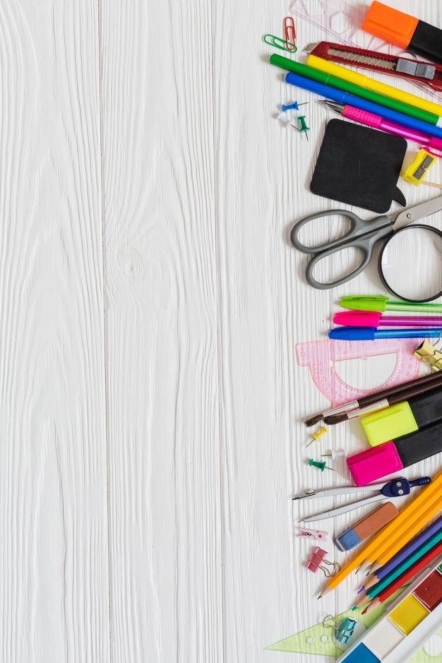 school supplies laid out on top of a white wooden table with scissors, markers and pencils