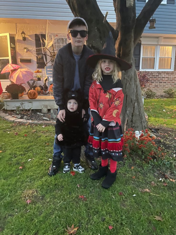 a man and two children dressed up for halloween