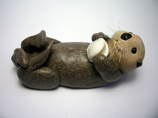 an animal figurine is laying on its back with it's eyes closed