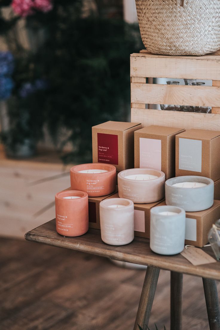 several candles are on a table with boxes