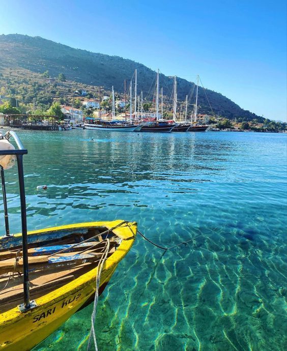 a yellow boat floating on top of a body of water