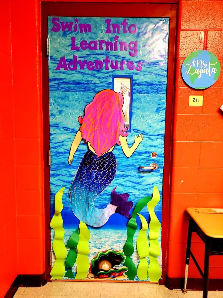 a door decorated with an image of a mermaid and the words swim into learning adventures