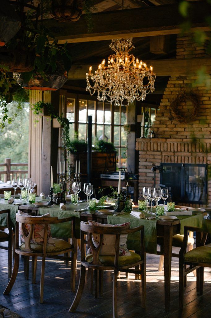 the dining room is set with green tablecloths