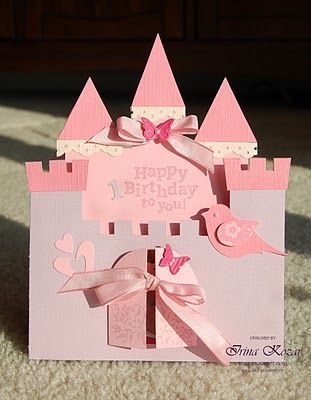 a birthday card with a pink castle on the front and a bow at the top