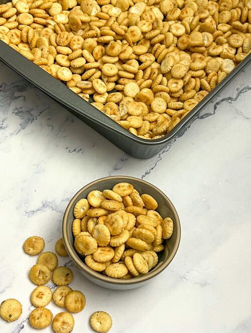 a bowl full of peanuts next to a pan filled with them