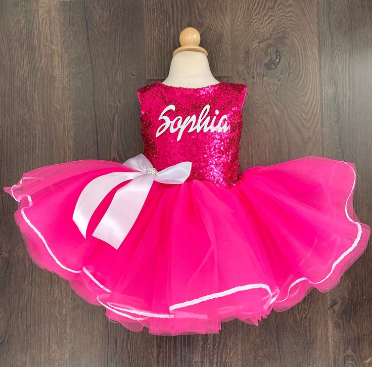 Beautiful leotard with tutu attached. The back is Lycra fabric and does not have sequin. Personalization is optional! These are perfect for birthday parties! Can be made as a long sleeve dress. Please message me for long sleeve. This listing is for short sleeve only! Party Ballet Tutu Dress With Ruffles, Pink Ruffled Tutu Dress For Party Season, Princess Style Fitted Sequin Dress For Pageant, Princess Style Fitted Sequin Dress For Pageants, Fitted Princess Style Sequin Dress For Pageants, Cute Pink Sequin Dress, Pink Fitted Princess Dress For Costume Party, Fitted Pink Princess Dress For Costume Party, Fitted Pink Tutu Dress For Party Season