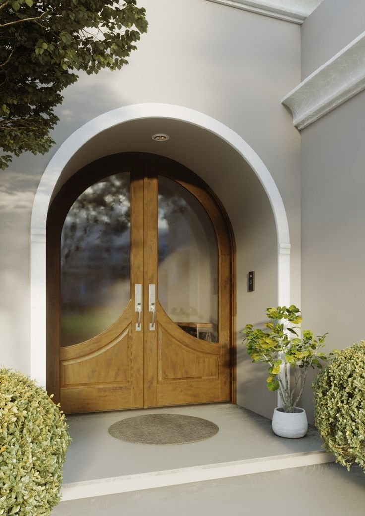 a wooden door is open on the outside of a house with two potted plants