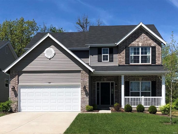 a house with two car garages in front of it