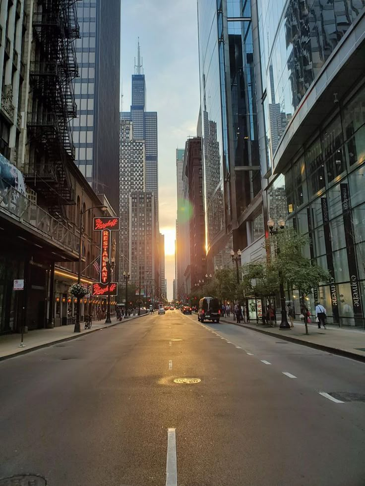 an empty city street with tall buildings in the background