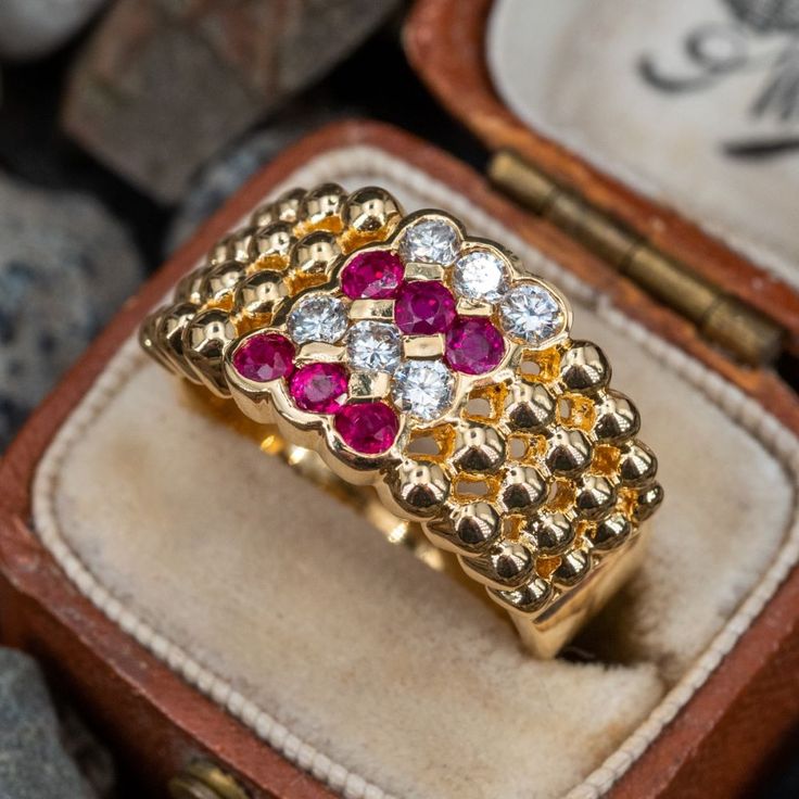 This delightful ring is accented with six (6), semi-bezel/channel set, round mixed cut natural rubies and six (6), semi-bezel/channel set, round brilliant cut diamonds. The ring measures 10.7mm at the top, rises 3.2mm above the finger, tapering to 3.9mm wide and 0.8mm thick at the base of the shank. This ring is currently a size 6.25. Vintage Ruby Rings, Ruby Ring Vintage, Ruby Rings, Diamond Band Ring, Ruby Engagement Ring, Red Gemstones, Diamond Rings Bands, Ruby Diamond, Channel Set