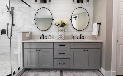 a bathroom with two sinks and mirrors on the wall next to each other in front of a walk in shower