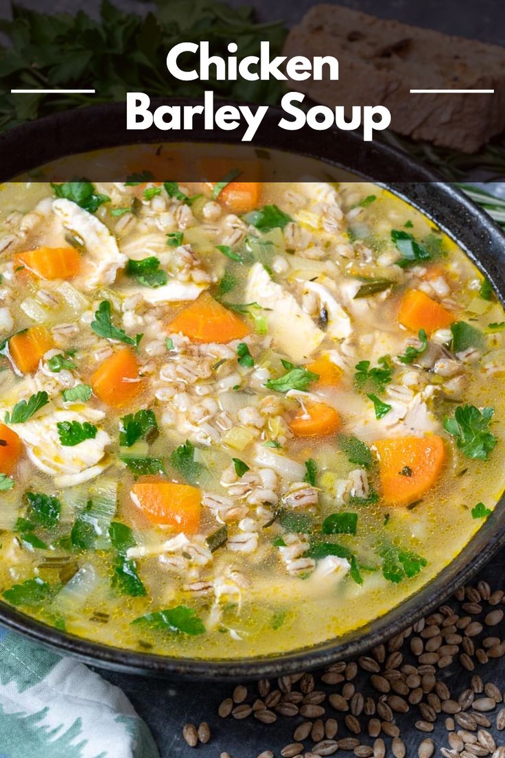 chicken barley soup with carrots and parsley in a black bowl