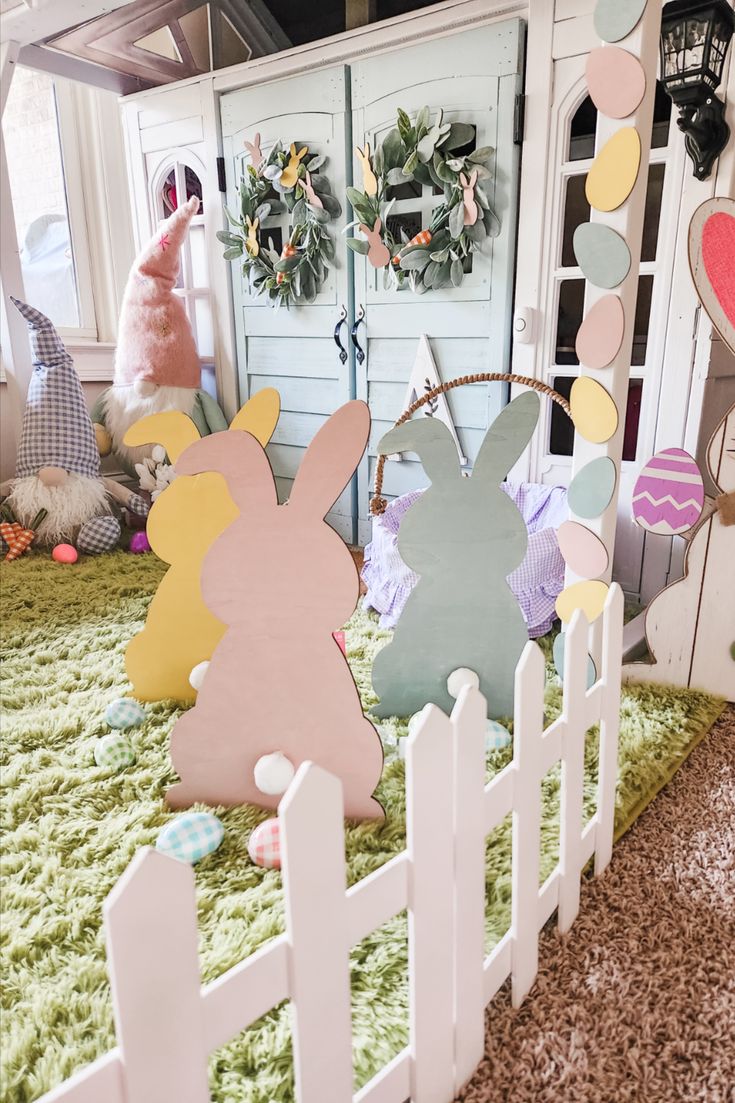 a white picket fence with easter decorations on it