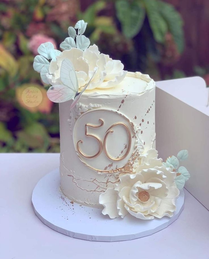 a 50th birthday cake with flowers on top