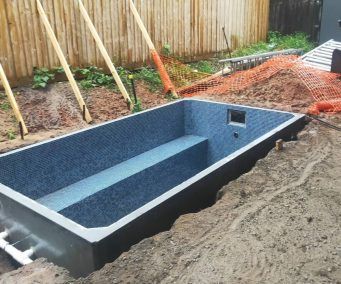 a pool being built in the middle of a yard