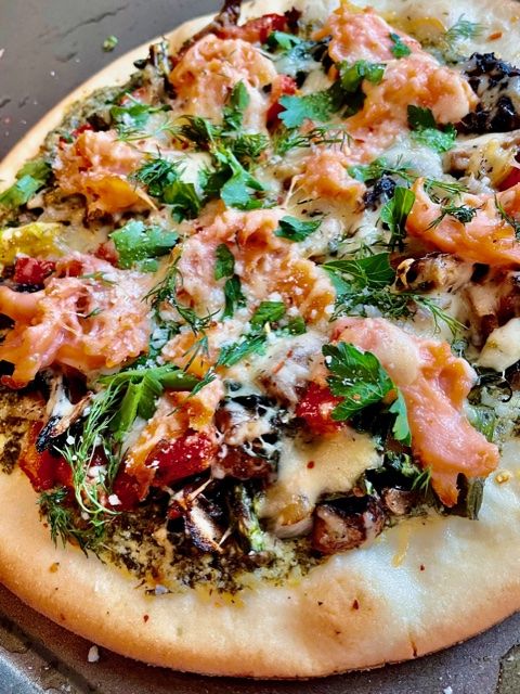 a pizza sitting on top of a pan covered in toppings