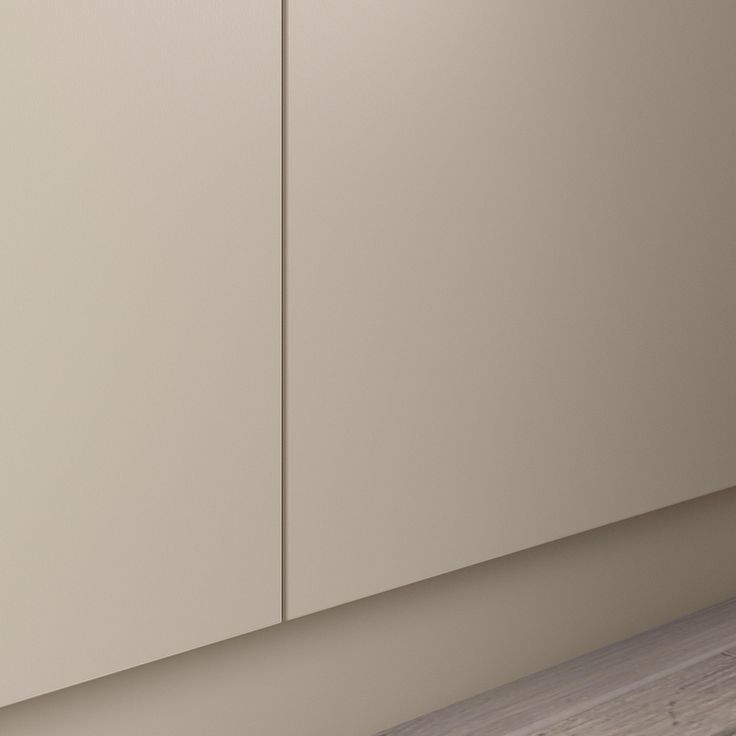 an empty kitchen with white cupboards and wood flooring on the wall, next to a counter top