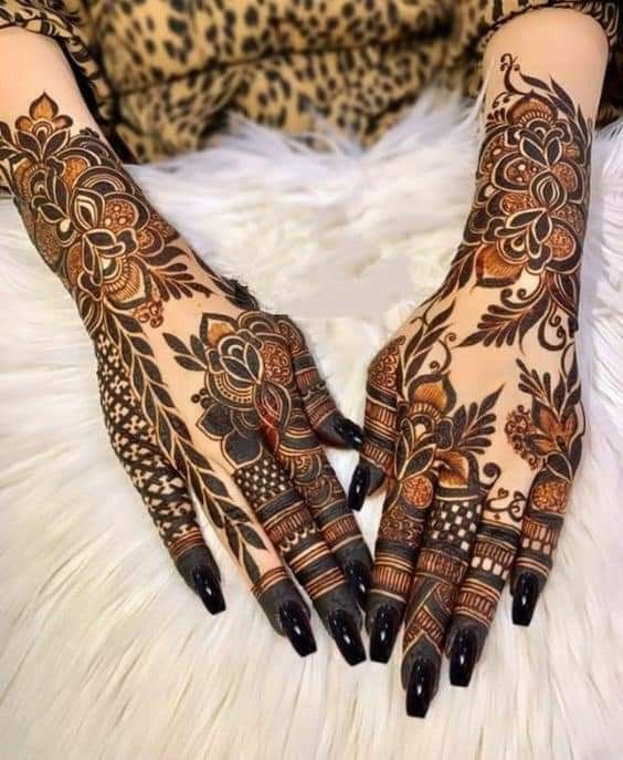 the hands are decorated with henna designs