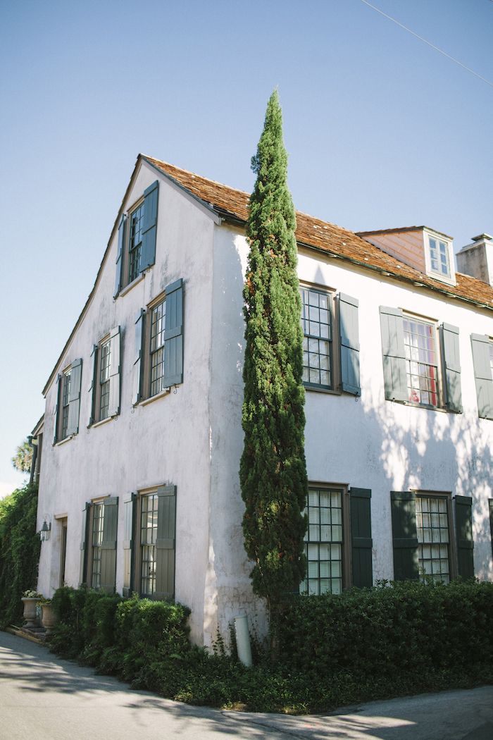 a large white building with lots of windows and ivy growing on it's side