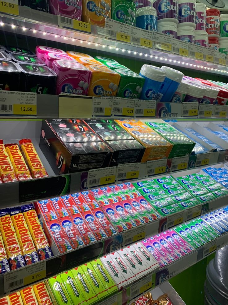 an assortment of drinks and snacks are on display in a grocery store or convenience store