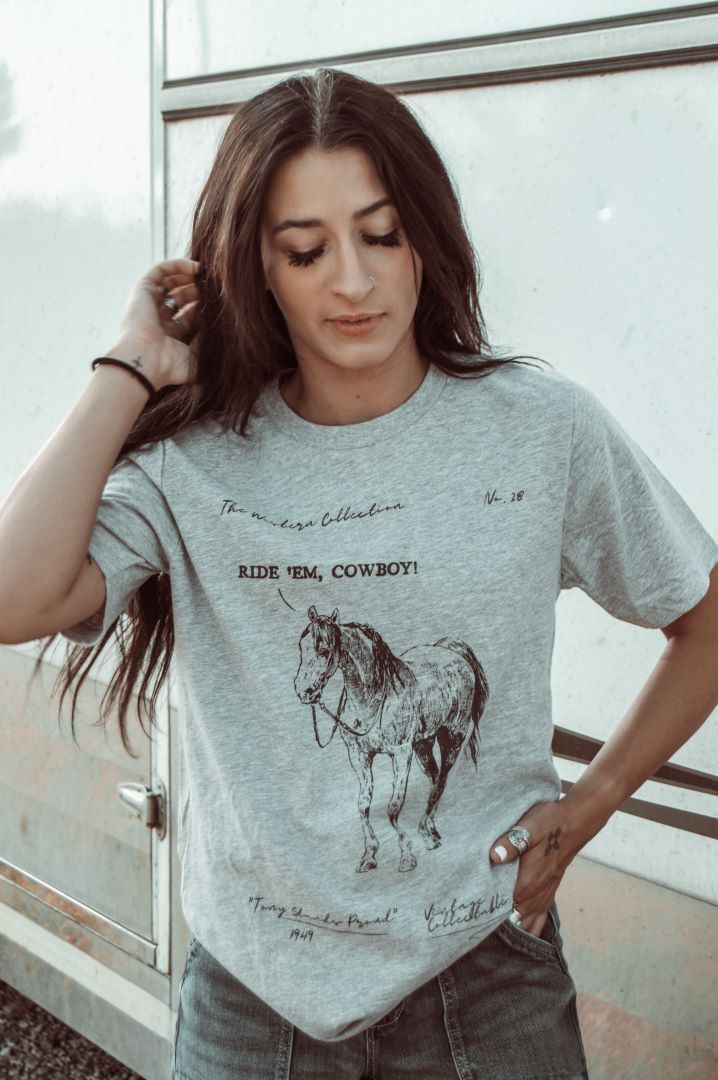 Introducing the Ride 'em Western Collection Graphic Tee - a must-have for any cowboy or cowgirl! Made with high-quality materials and featuring a stunning western design, this tee will keep you comfortable and stylish all day long. Perfect for casual outings or adding a touch of western flair to your wardrobe. 100% Cotton Western Design, Must Haves, Shirts Tops, Graphic Tee, Cowboy, Graphic Tees, Purses And Bags, Wardrobe, High Quality