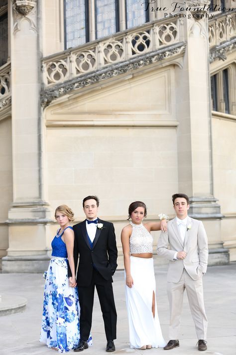 three young people standing in front of a building wearing formal wear and tuxedos