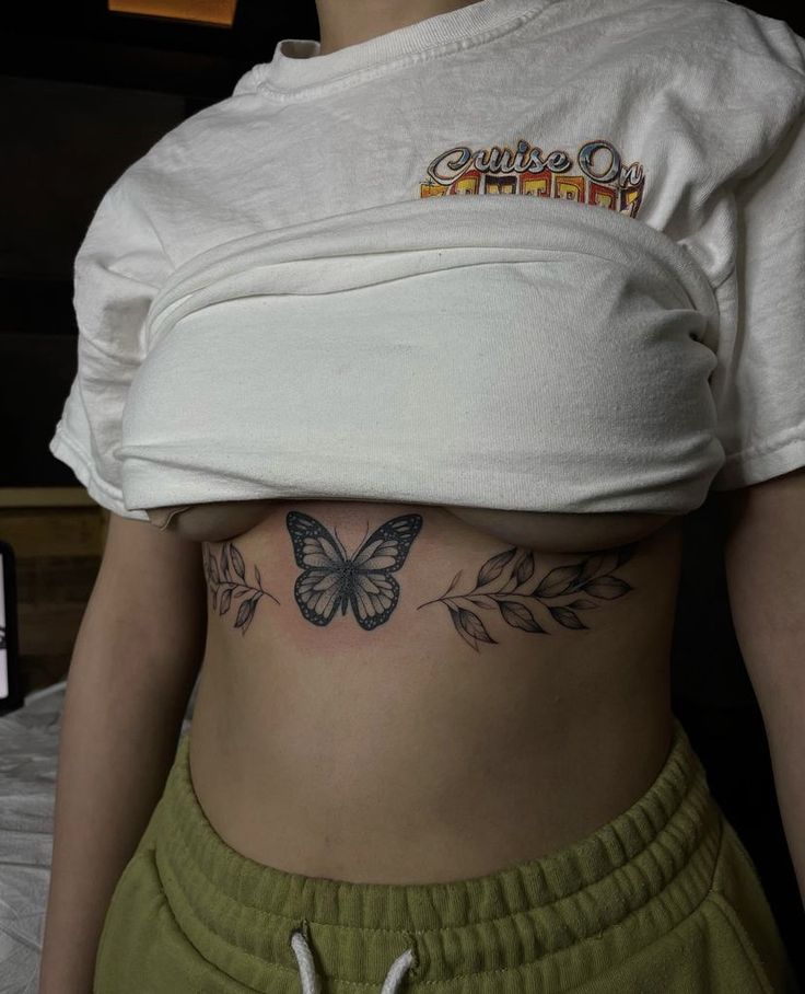 a woman with a butterfly tattoo on her stomach