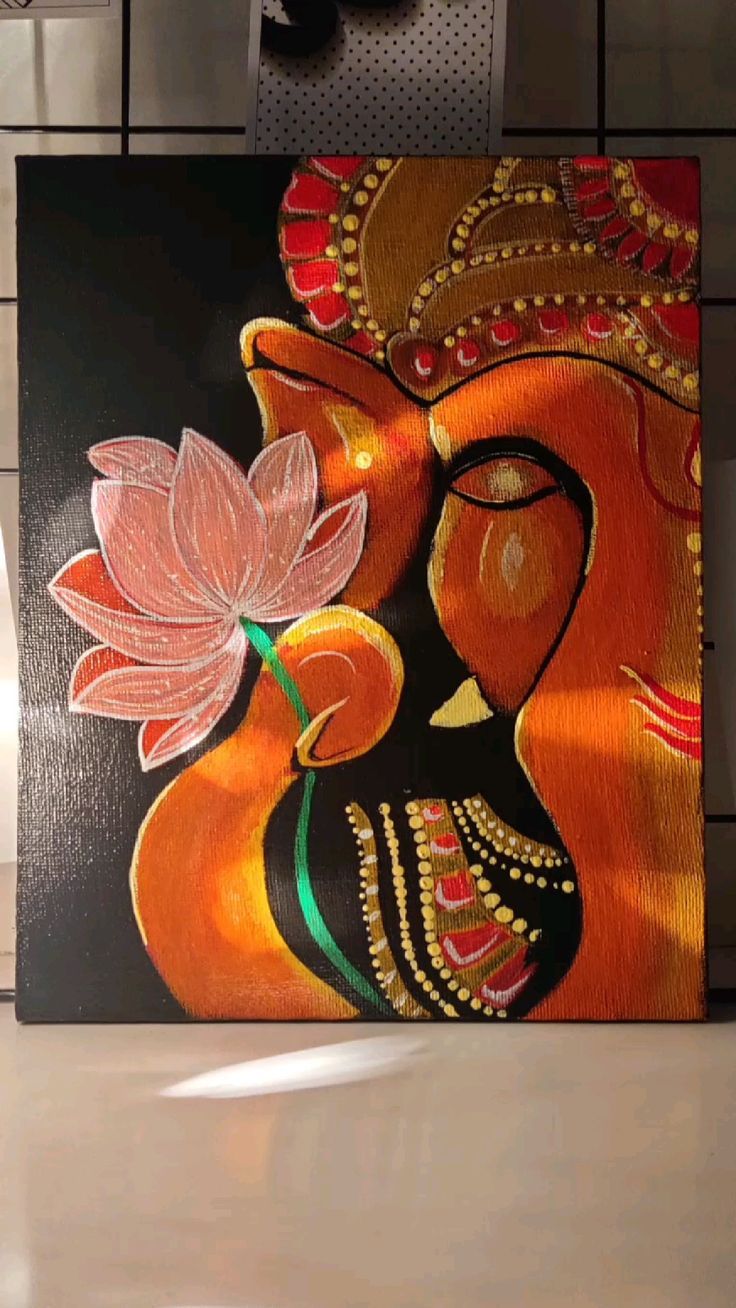 a painting on a wall with a flower in its mouth and an elephant's face painted on it