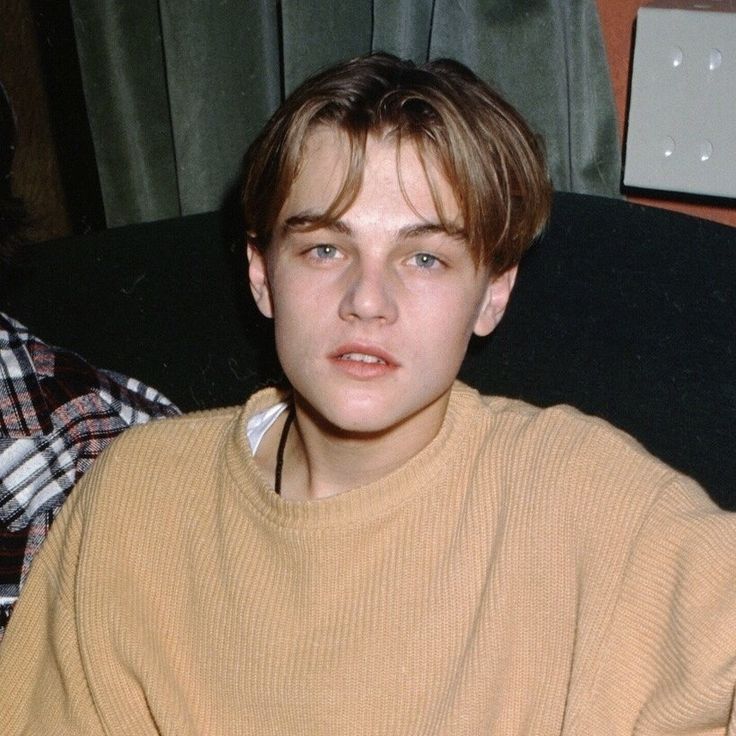 two young men sitting next to each other on a couch