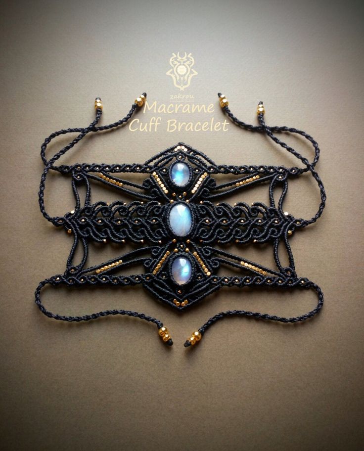 an intricate black and gold necklace with beads