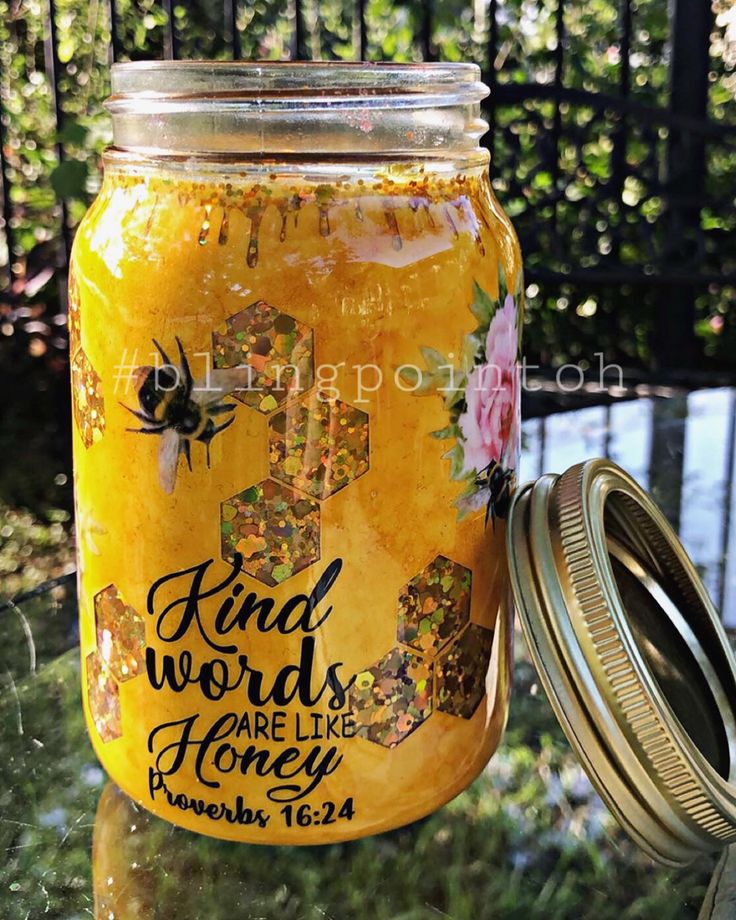 a jar filled with honey sitting on top of a table