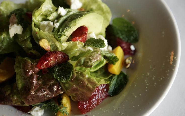 a white plate topped with salad and dressing