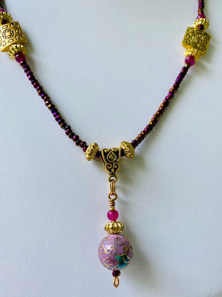 This precious necklace sparkles in Gold and Purple. The centerpiece is antique enamel. Purple Enamel Necklace For Gift, Purple Enamel Necklace For Gifts, Gold Czech Glass Pendant Necklace, Elegant One-of-a-kind Gold Beaded Necklaces, Handmade Pink Enamel Necklaces, Spiritual Enamel Round Pendant Necklace, Gold Czech Glass Round Necklace, Gold Spiritual Decorative Necklace, Decorative Gold Spiritual Necklace