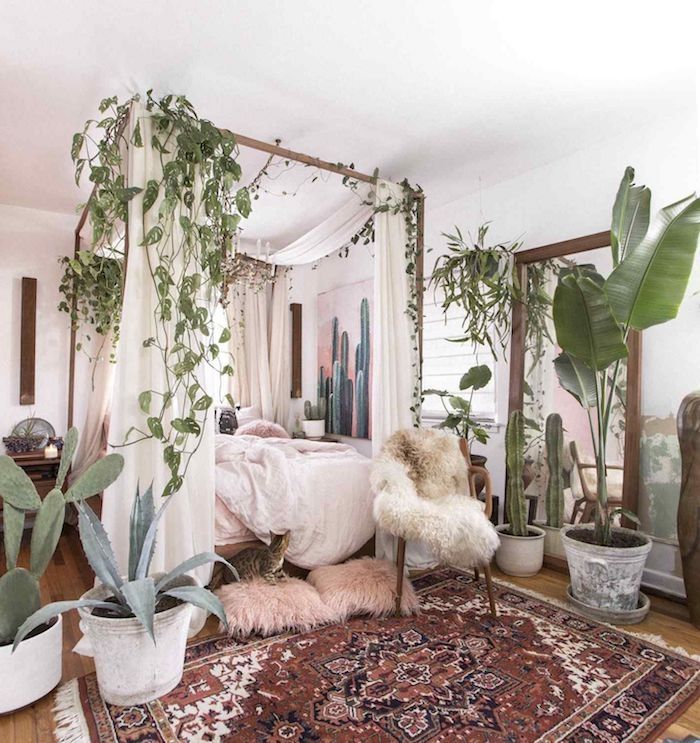 a bedroom with plants and rugs on the floor