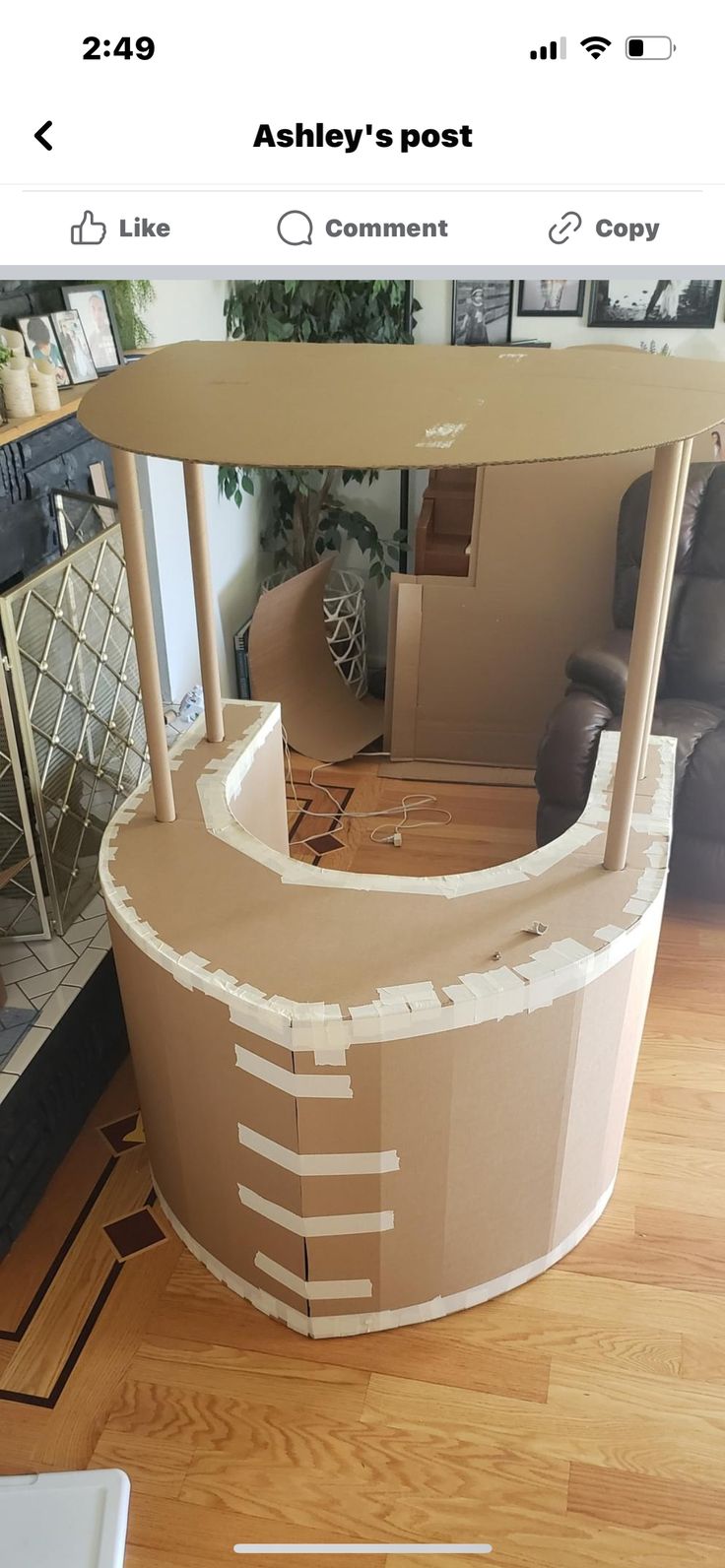 a cardboard counter sitting on top of a hard wood floor