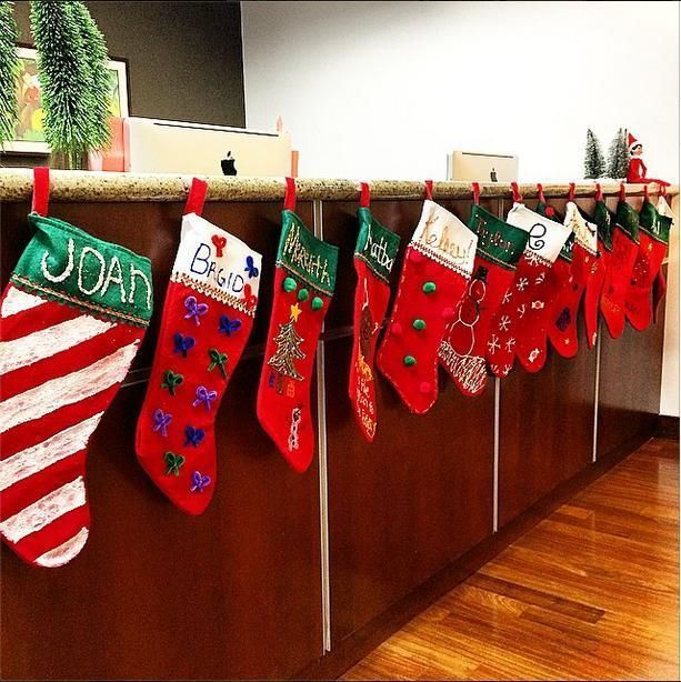 christmas stockings hanging on the wall in an office