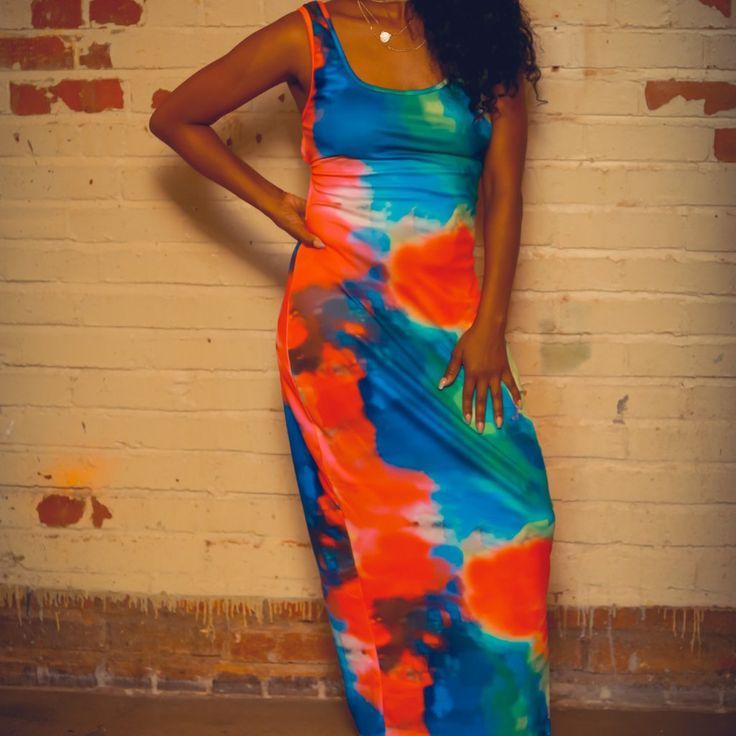 A Simple Yet Bold Maxi Dress With A Bold Abstract Print Diffusing Bright Shades Of Blue And Orange. It's Partially Backless With A Beautiful Lattice Pattern Created With Straps. Material: 95% Polyester, 5% Spandex Scoop Neck Sleeveless Maxi Length Vibrant Orange Sleeveless Maxi Dress, Vibrant Blue Fitted Maxi Dress, Blue Fitted Maxi Dress With Vibrant Print, Fitted Blue Maxi Dress With Vibrant Print, Ruffle Floral Maxi Dress, Off Shoulder Floral Dress, Muumuu Dress, Ribbed Maxi Dress, Paisley Maxi Dress