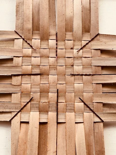 a piece of wood that has been cut into squares and arranged in the shape of a cross