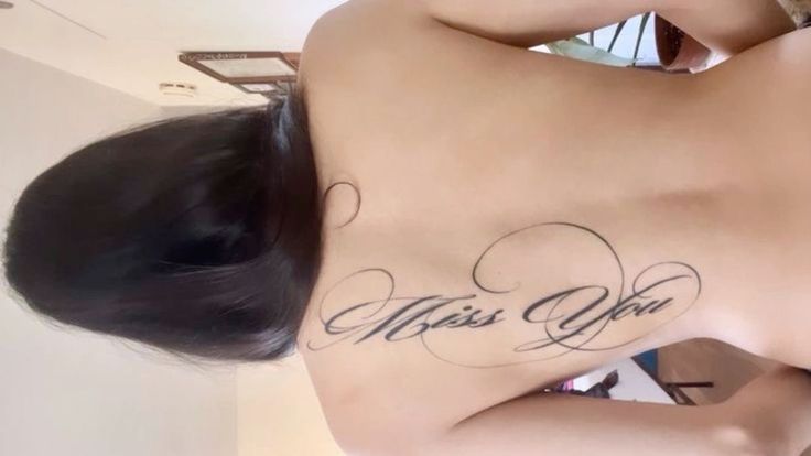 a woman with a tattoo on her back