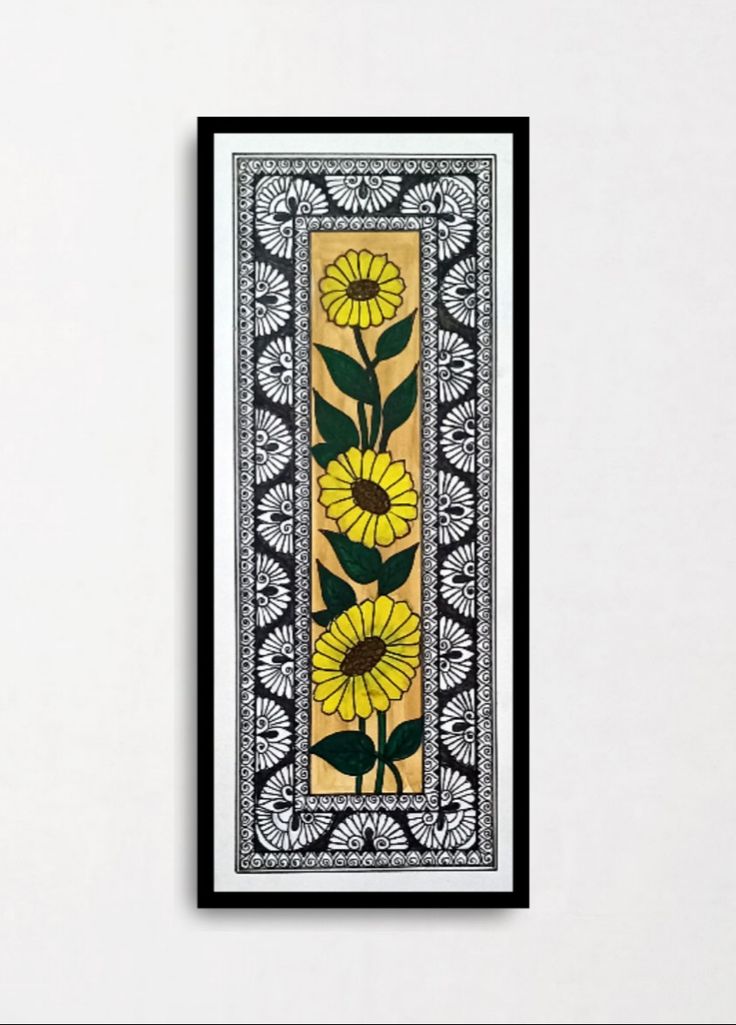 a yellow and black painting with flowers on it's side hanging on a wall