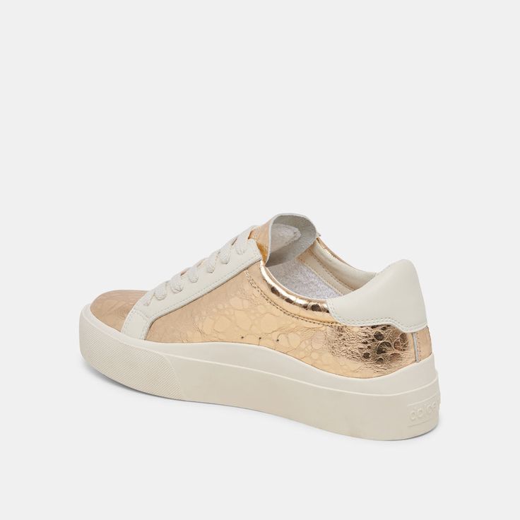 ZAYN 360 SNEAKERS GOLD DISTRESSED LEATHER – Dolce Vita Gold Leather Sneakers With Gum Sole, Gold Low-top Sneakers With Contrast Sole, Metallic Low-top Sneakers For Spring, Spring Metallic Low-top Sneakers, Gold High-top Sneakers With Gum Sole, Gold High-top Sneakers With Contrast Sole, Trendy Gold Low-top Sneakers, Modern Gold High-top Sneakers, Gold Sneakers With Vulcanized Sole For Streetwear