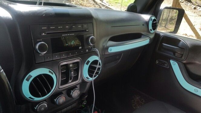 the interior of a car with blue trims and dash lights, steering wheel controls