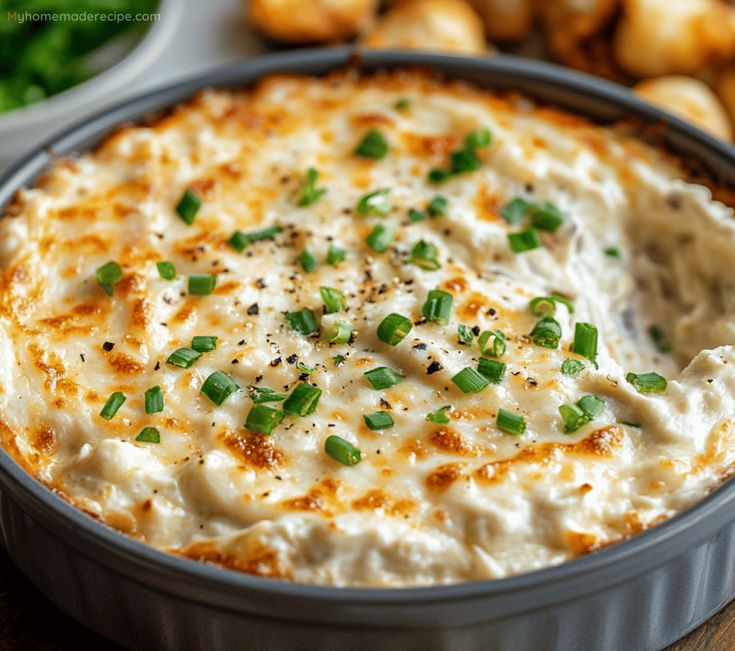 a casserole dish with cheese and green onions