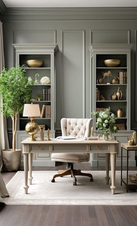 an elegant home office with gray walls and white furniture, along with gold vases