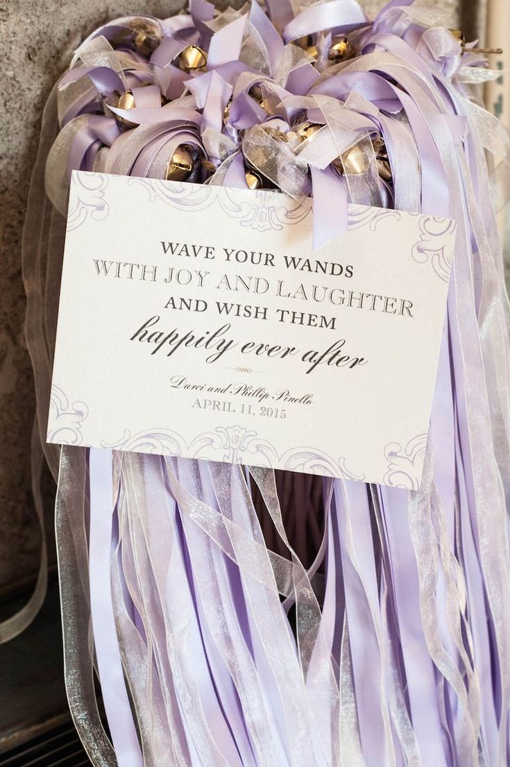 a purple and white wreath with a sign that says, wave your wands without a thoughter and wish them happy every day