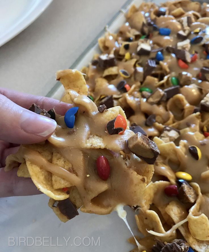 someone is holding up some kind of snack with m & m toppings on it