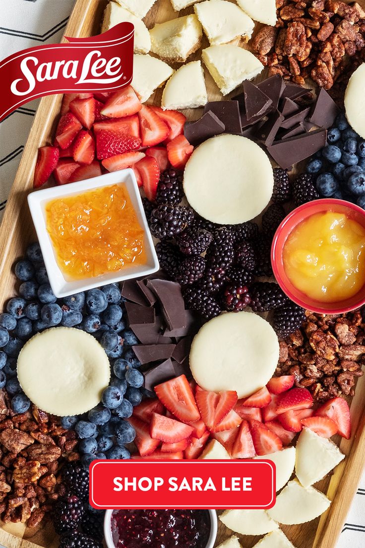 a wooden tray filled with fruit and crackers