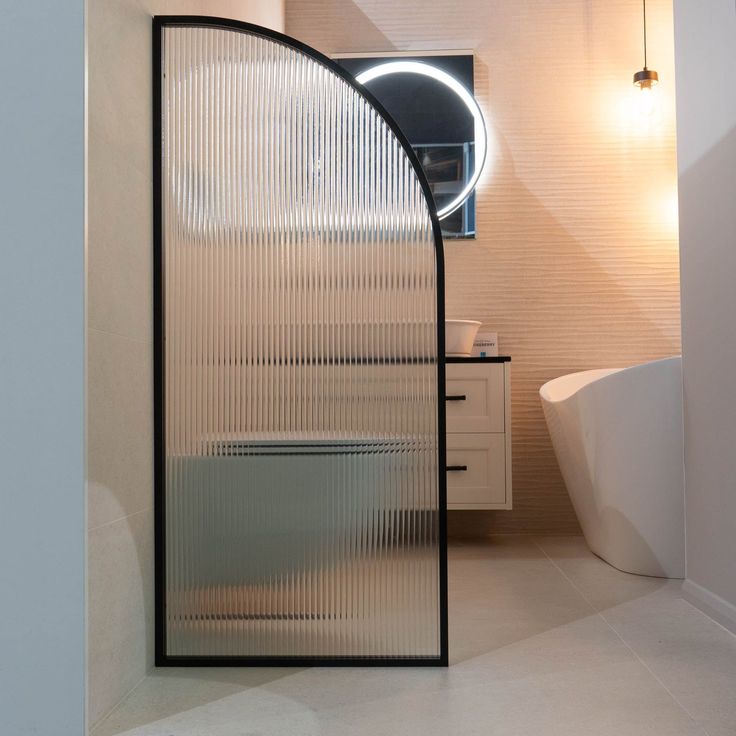 a bathroom with a glass shower door next to a bathtub and sink in it