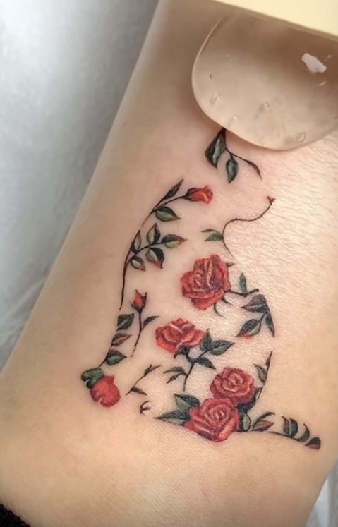 a woman's leg with roses on it and the word love written in cursive writing