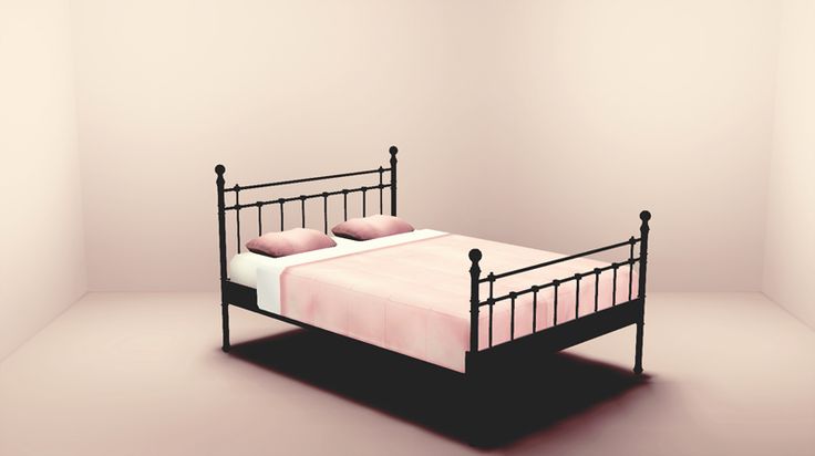 a black metal bed frame with pink sheets and pillows on it in a white room